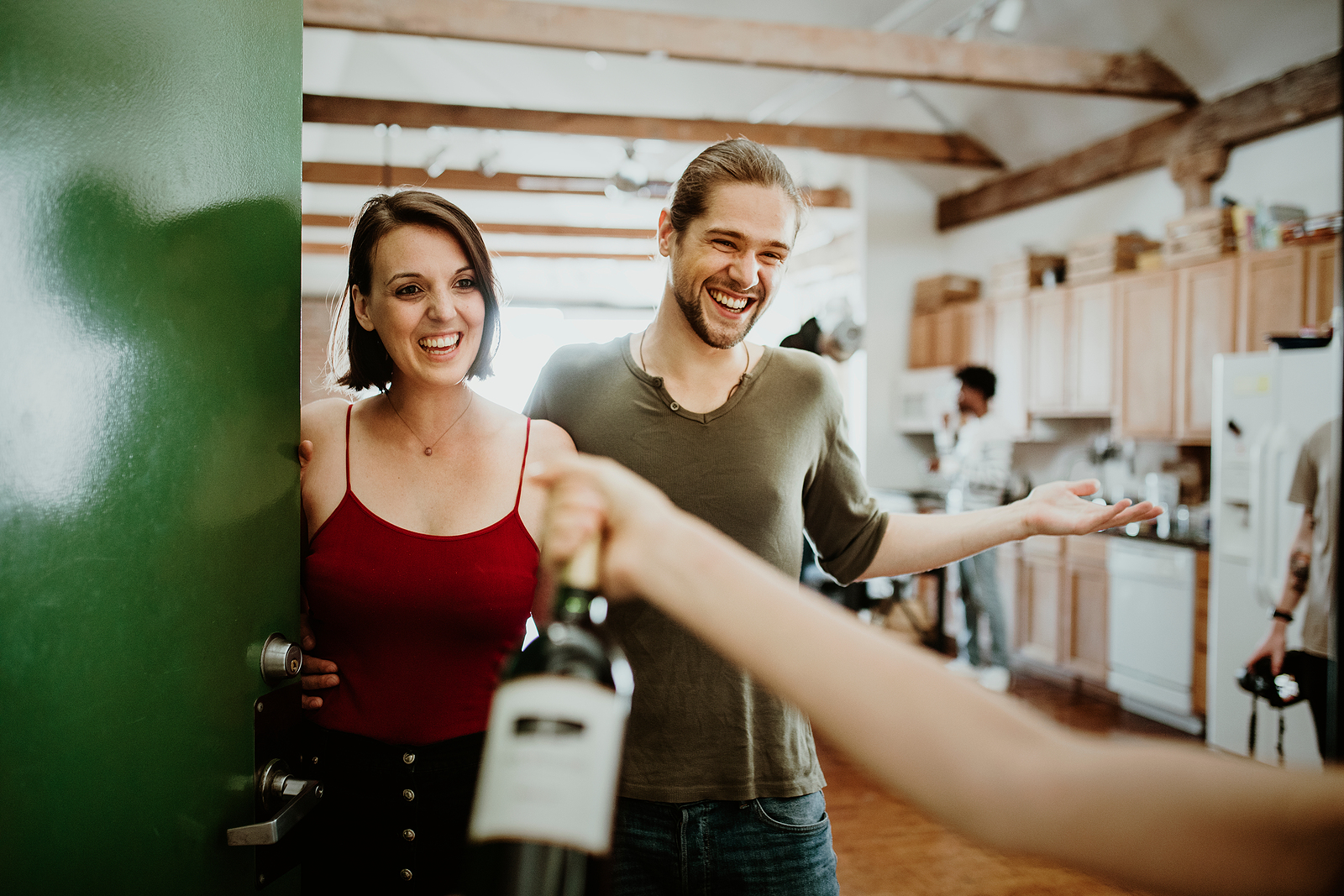 Woman presenting a bottle of red wine