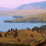 Scenic overlook of Wild Horse Island and Flathead Lake in northwest Montana with rolling hills and mountain views.